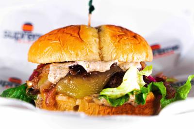 A 6oz gourmet halal beef burger served on a toasted and buttered brioche bun with melted Pepper Jack cheese, grilled red onion and lettuce topped with a special mild jerk-mayo sauce. 
